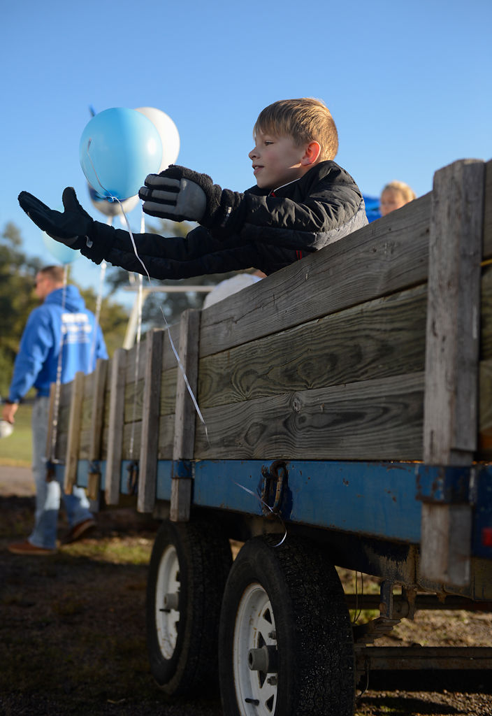 Wyatt Cunningham, 9, plays with a half-inflated balloon on the Shark Window Cleaning float